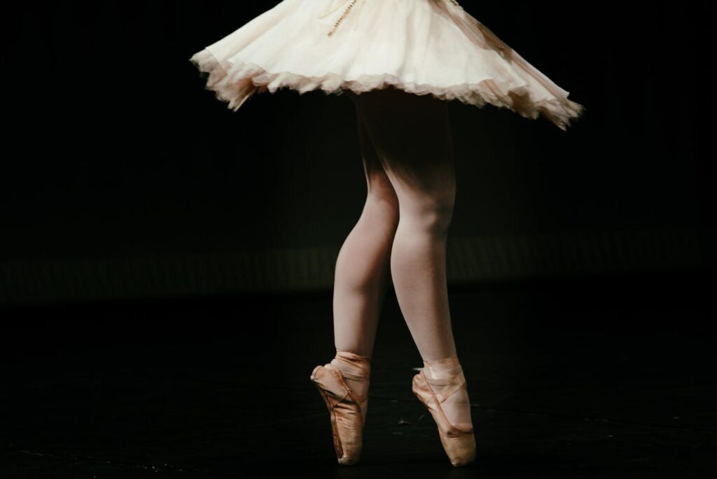 The Art of Drawing Readers In: Your attractive post title goes here Close-up of a ballerina's legs in pointe shoes performing on stage, showcasing graceful movement.