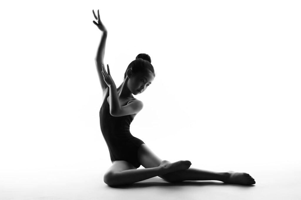 Mastering the First Impression: Your intriguing post title goes here Silhouette of a graceful young dancer in an artistic ballet pose, showcasing elegance and skill.