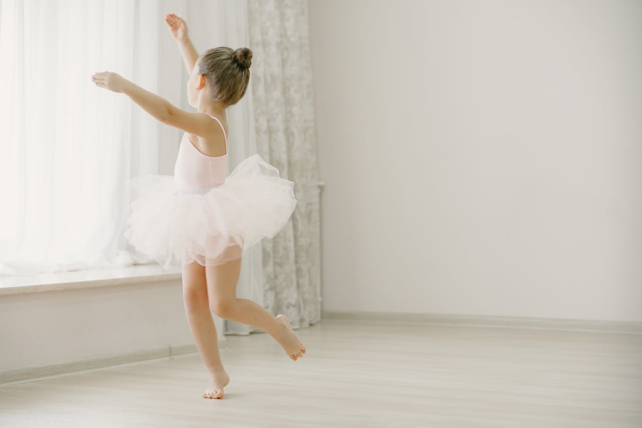 Crafting Captivating Headlines: Your awesome post title goes here A young girl in a tutu gracefully practices ballet in a bright, minimalistic room.
